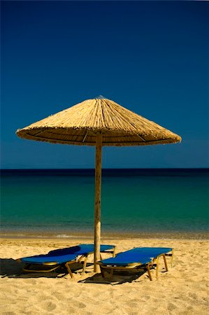 paradise beach mykonos - Two lounge chairs and umbrella  on Paradise Beach , Mykonos , Greece. Photographie de stock - Aubaine LD & Abonnement, Code: 400-05143727