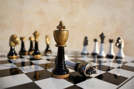 The end of a duel on a chessboard, the dark  wins the light king is fallen Fotografie stock - Microstock e Abbonamento, Codice: 400-05154099