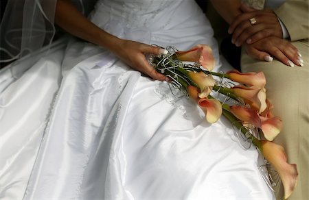Bride holding colorful wedding bouquet, groom is sitting near Stockbilder - Microstock & Abonnement, Bildnummer: 400-05154679