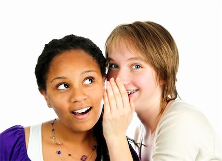 simsearch:400-05108874,k - Isolated portrait of two diverse teenage girl friends whispering Photographie de stock - Aubaine LD & Abonnement, Code: 400-05157048