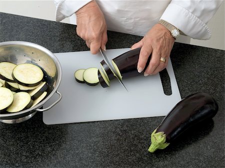 simsearch:632-05604290,k - Chef slicing eggplant Stock Photo - Budget Royalty-Free & Subscription, Code: 400-05157112