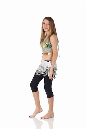 Young Caucasian belly dancing girl in beautiful decorated clothes on white background and reflective floor. Not isolated Foto de stock - Super Valor sin royalties y Suscripción, Código: 400-05158791