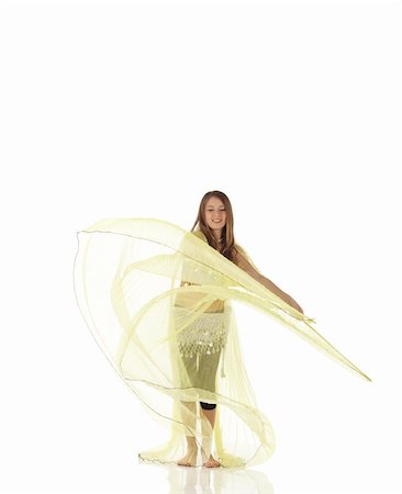 Young Caucasian belly dancing girl in beautiful decorated clothes on white background and reflective floor. Not isolated Foto de stock - Super Valor sin royalties y Suscripción, Código: 400-05158899