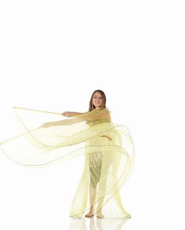 Young Caucasian belly dancing girl in beautiful decorated clothes on white background and reflective floor. Not isolated Foto de stock - Super Valor sin royalties y Suscripción, Código: 400-05158900