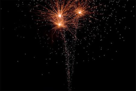 sparking light in sky - Fireworks exploding in the dark of the evening sky. Stock Photo - Budget Royalty-Free & Subscription, Code: 400-05150157