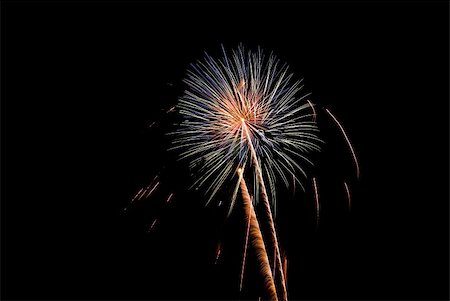 simsearch:400-06477770,k - Fireworks exploding in the dark of the evening sky. Photographie de stock - Aubaine LD & Abonnement, Code: 400-05150165