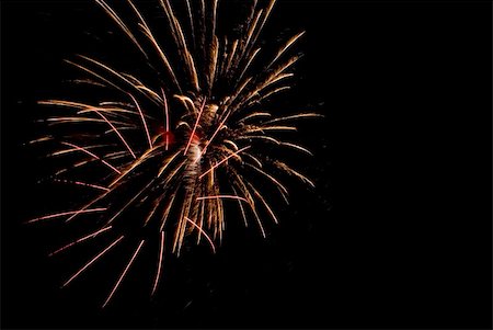 simsearch:400-06477770,k - Fireworks exploding in the dark of the evening sky. Photographie de stock - Aubaine LD & Abonnement, Code: 400-05150163