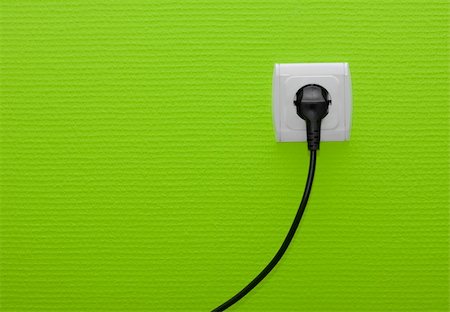 Electric outlet on green wall with cable plugged Stock Photo - Budget Royalty-Free & Subscription, Code: 400-05150199