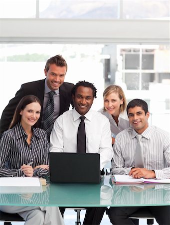 International business team working together smiling at the camera Stock Photo - Budget Royalty-Free & Subscription, Code: 400-05150386