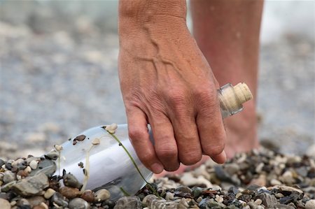 Transparent glass bottle with a note on seacoast Stock Photo - Budget Royalty-Free & Subscription, Code: 400-05151384