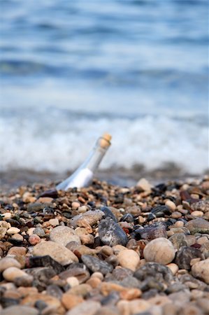 Transparent glass bottle with a note on seacoast Stock Photo - Budget Royalty-Free & Subscription, Code: 400-05151382