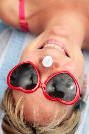 Woman laughing with sunscreen on her nose Stock Photo - Budget Royalty-Free & Subscription, Code: 400-05151979