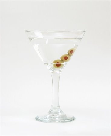 A vodka martini with three fresh olives inside. Stock Photo - Budget Royalty-Free & Subscription, Code: 400-05152428