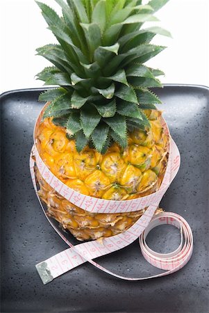 simsearch:400-04315300,k - pineapple on a black plate with tape meter isolated on white background Foto de stock - Super Valor sin royalties y Suscripción, Código: 400-05152447