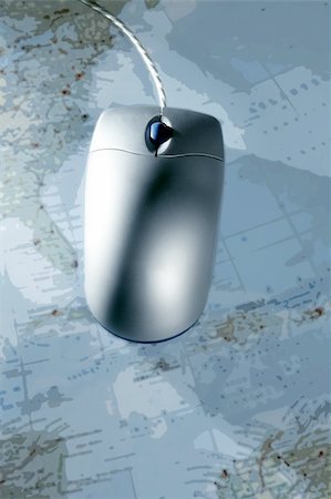 scrolled up paper - Computer silver wired mouse over blue blurred map Stock Photo - Budget Royalty-Free & Subscription, Code: 400-05152763