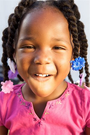 An adorable little african american girl in a pink shirt Stock Photo - Budget Royalty-Free & Subscription, Code: 400-05153082