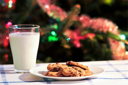 Plate of cookies and glass of milk near Christmas tree Stock Photo - Budget Royalty-Free & Subscription, Code: 400-05153701