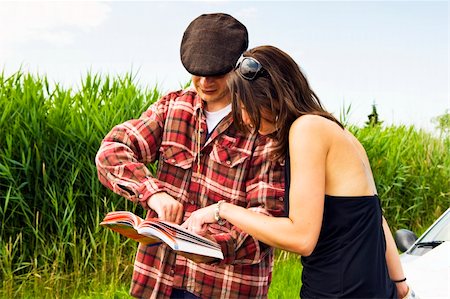 farmer help - Young woman asking a farmer for advice on where to go, consulting a guide book Stock Photo - Budget Royalty-Free & Subscription, Code: 400-05153984
