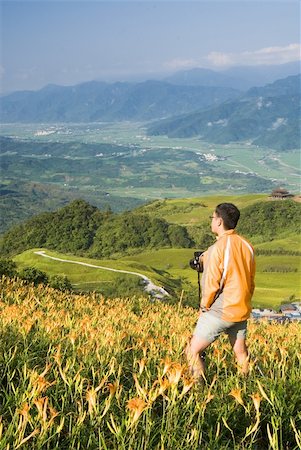 It is a cameraman stand on the tiger lily farm. Stock Photo - Budget Royalty-Free & Subscription, Code: 400-05165509