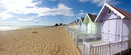 distant people uk - mersea beach huts and cloudscape in summer Stock Photo - Budget Royalty-Free & Subscription, Code: 400-05165585