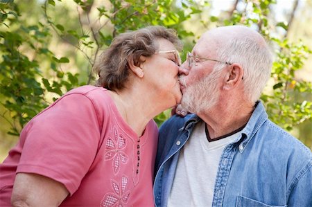 simsearch:400-06139916,k - Loving Senior Couple Kissing Enjoying the Outdoors Together. Stock Photo - Budget Royalty-Free & Subscription, Code: 400-05166004