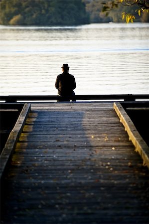 A man sitting at the end of a dock Photographie de stock - Aubaine LD & Abonnement, Code: 400-05166364