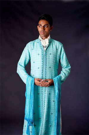 desi guy - Beautiful authentic Indian hindu man in typical ethnic groom attire standing with hands together. Bangali male wearing a light blue agua decorated Dhoti with shawl. Stock Photo - Budget Royalty-Free & Subscription, Code: 400-05166513