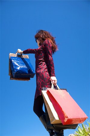 woman on red dress with shopping bags Stock Photo - Budget Royalty-Free & Subscription, Code: 400-05167747