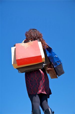 woman on red dress with shopping bags Stock Photo - Budget Royalty-Free & Subscription, Code: 400-05167760