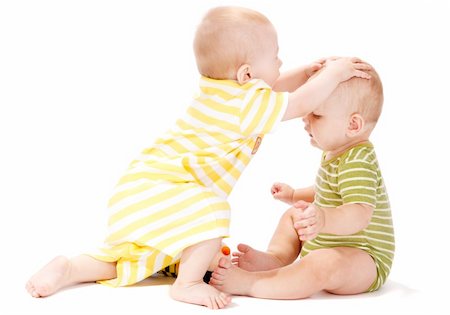 Two baby boys playing together, isolated, over white Stock Photo - Budget Royalty-Free & Subscription, Code: 400-05168816