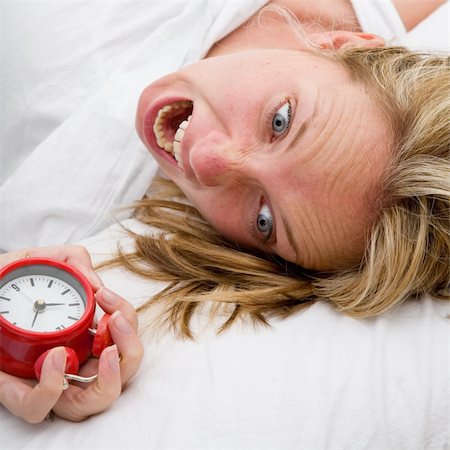 simsearch:700-05974049,k - Woman with red alarm clock representing lateness or a deadline Stock Photo - Budget Royalty-Free & Subscription, Code: 400-05168965