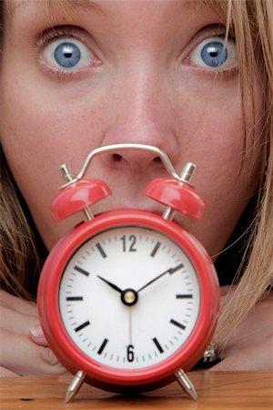 simsearch:700-05974049,k - Woman with red alarm clock representing lateness or a deadline Stock Photo - Budget Royalty-Free & Subscription, Code: 400-05168962