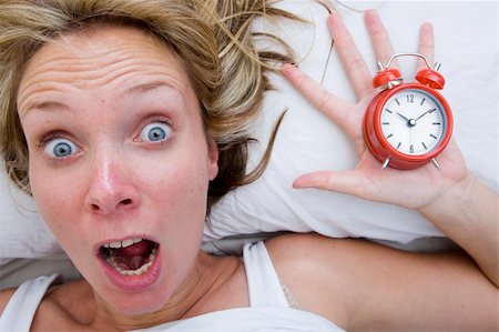 simsearch:700-05974049,k - Woman with red alarm clock representing lateness or a deadline Stock Photo - Budget Royalty-Free & Subscription, Code: 400-05168970