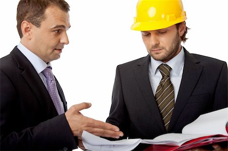 two business people, one with helmet are looking at plans Stock Photo - Budget Royalty-Free & Subscription, Code: 400-05169046