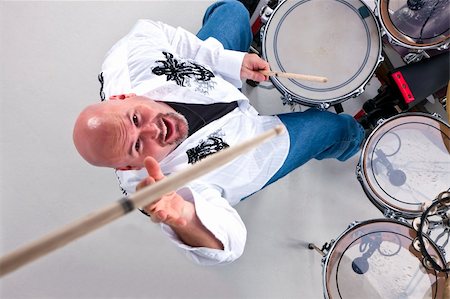 simsearch:6111-06837386,k - Drummer in action photographed from overhead with a drumstick being thrown in the air Foto de stock - Royalty-Free Super Valor e Assinatura, Número: 400-05169575