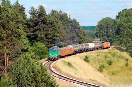 Freight train hauled by the diesel locomotive is passing its route Stock Photo - Budget Royalty-Free & Subscription, Code: 400-05160826