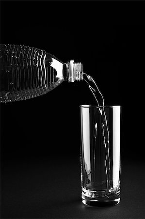 Mineral water being poured into a glass against a black background Stock Photo - Budget Royalty-Free & Subscription, Code: 400-05161248