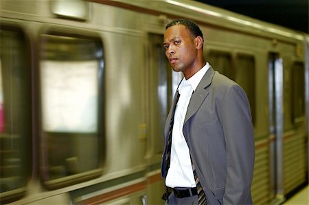An African-American businessman awaits his commuter train Photographie de stock - Aubaine LD & Abonnement, Code: 400-05161375