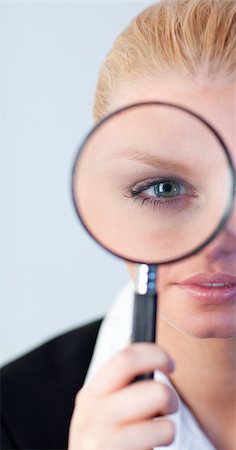 simsearch:400-04554899,k - Young Serious Business woman looking through a magnifying Glass Stock Photo - Budget Royalty-Free & Subscription, Code: 400-05162001