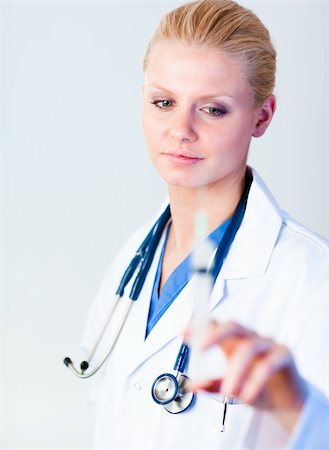 simsearch:400-05320263,k - Serious Doctor holding a needle with camera focus on the doctor Photographie de stock - Aubaine LD & Abonnement, Code: 400-05162108