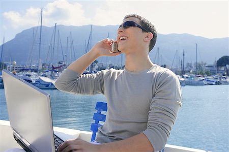 Businessman working with computer on a boat, nice outdoor office Stock Photo - Budget Royalty-Free & Subscription, Code: 400-05162673