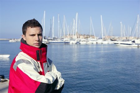 Handsome boy on blue marina harbor with red marine coat Stock Photo - Budget Royalty-Free & Subscription, Code: 400-05162681