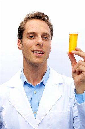 A young doctor holding pills looking at camera Stock Photo - Budget Royalty-Free & Subscription, Code: 400-05163746