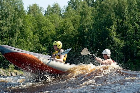 simsearch:400-05362222,k - Kayakers sporting a kayak cuts through water Stock Photo - Budget Royalty-Free & Subscription, Code: 400-05163910