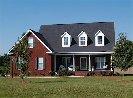 simsearch:400-05175746,k - Two story brick residential home with porch swing. Fotografie stock - Microstock e Abbonamento, Codice: 400-05174079