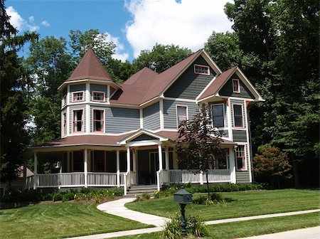 simsearch:400-05175746,k - New two story Victorian residential home with vinyl or board siding on the facade styled after an old-fashioned historical house with bay windows, gingerbread and a turret. Fotografie stock - Microstock e Abbonamento, Codice: 400-05174108