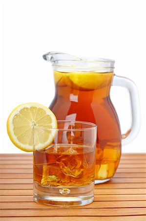 Ice tea pitcher and glasss with lemon and icecubes on wooden background. Focus at front and shallow depth of field Stock Photo - Budget Royalty-Free & Subscription, Code: 400-05174227