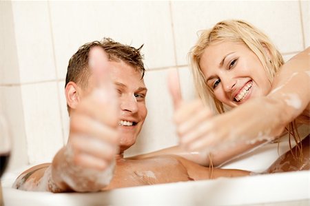 Smiling young couple showing thumbs up Stock Photo - Budget Royalty-Free & Subscription, Code: 400-05174686