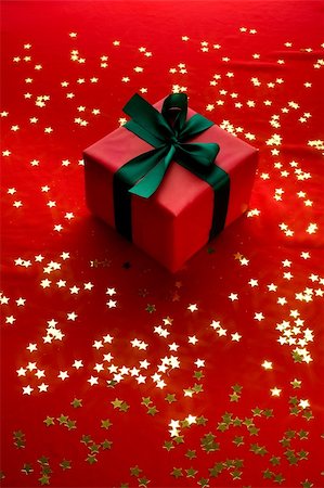 simsearch:400-06070265,k - Close-up xmas gift over golden stars background Stock Photo - Budget Royalty-Free & Subscription, Code: 400-05174823
