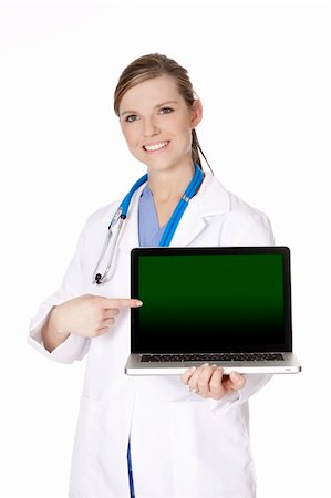 doctor and sales rep - Beautiful Caucasian doctor holding a laptop computer and pointing at the screen.  There is clipping path around the computer screen Stock Photo - Budget Royalty-Free & Subscription, Code: 400-05175474